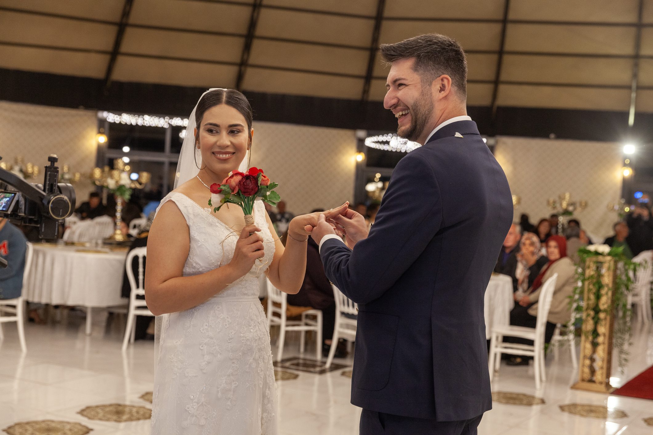 Bride and groom exchanging rings during wedding ceremony.