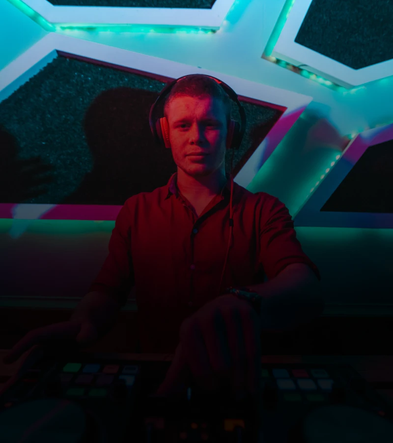 Musician mixing tracks in club setting