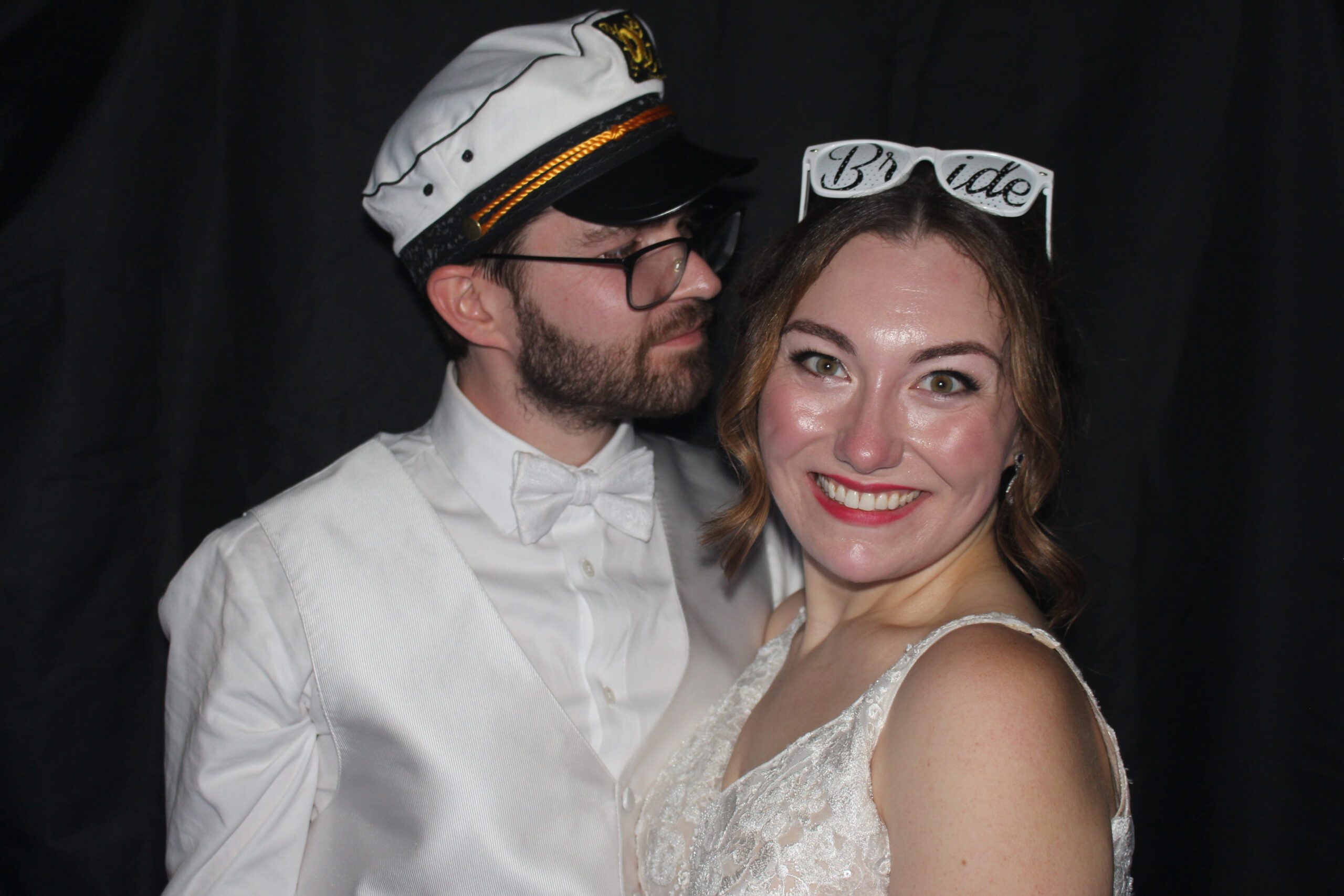 Couple dressed elegantly, smiling and posing together.